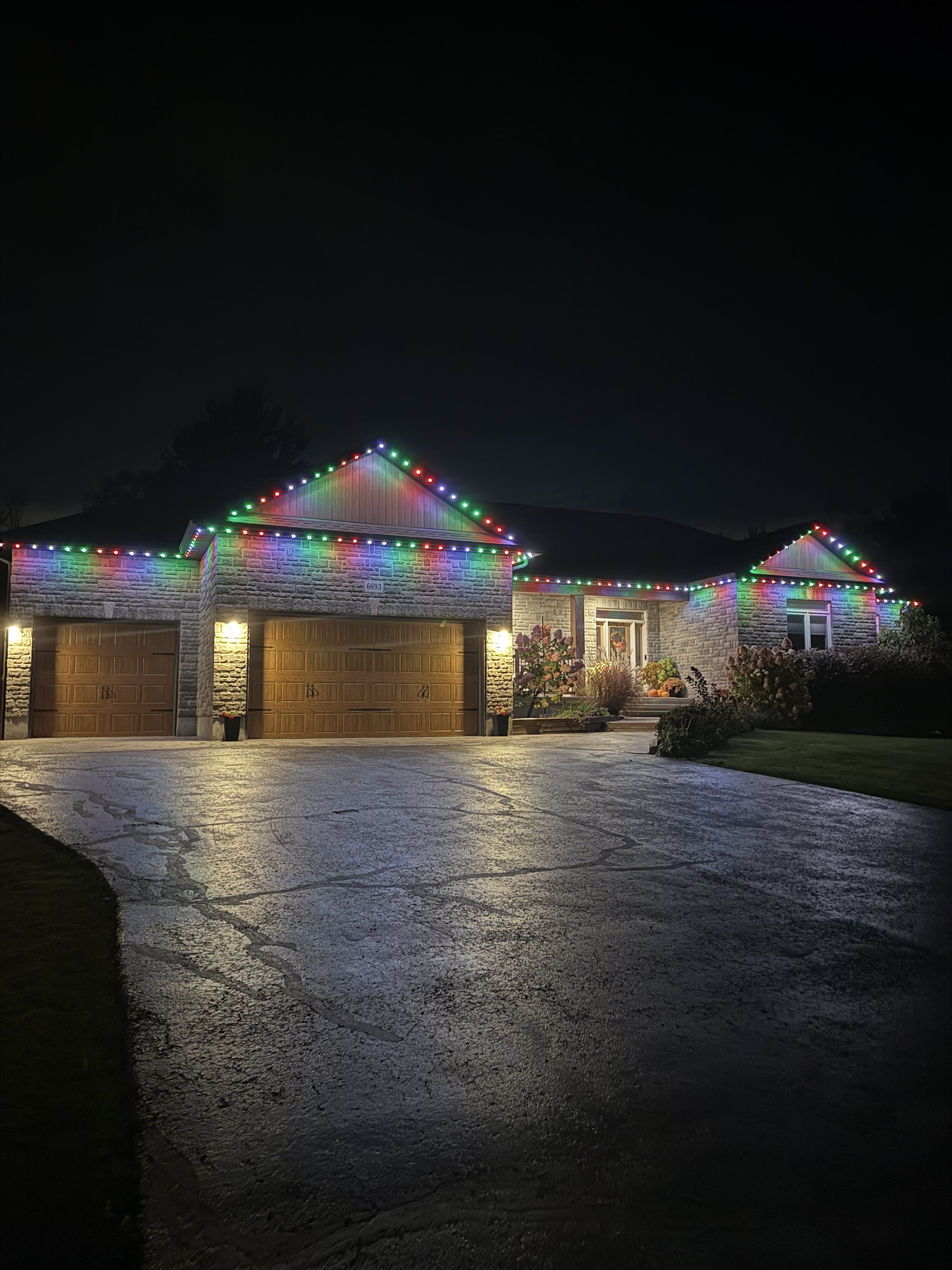 Colourful permanent lighting on a stone Ottawa home