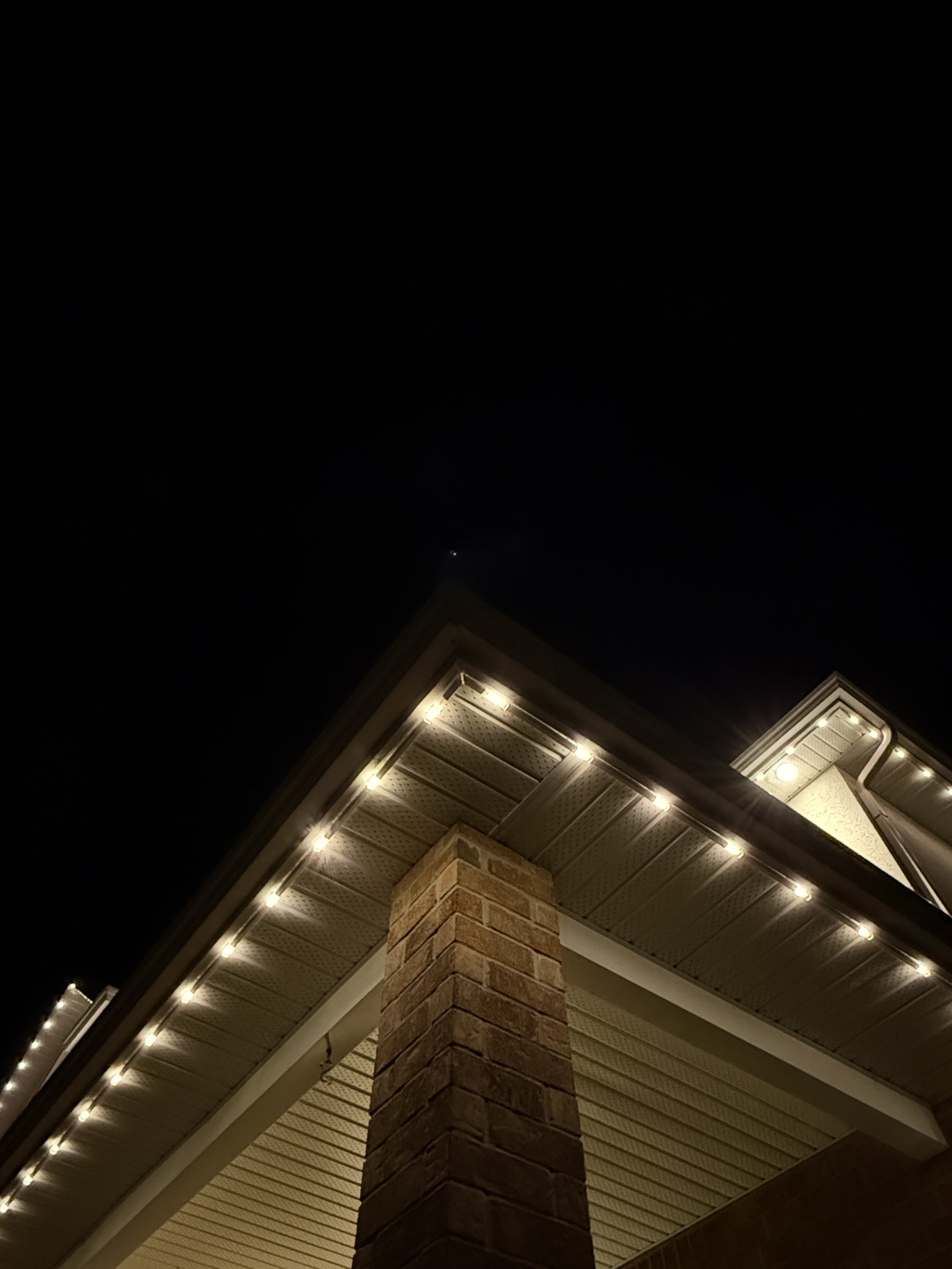 Warm white permanent light modules installed neatly beneath a soffit