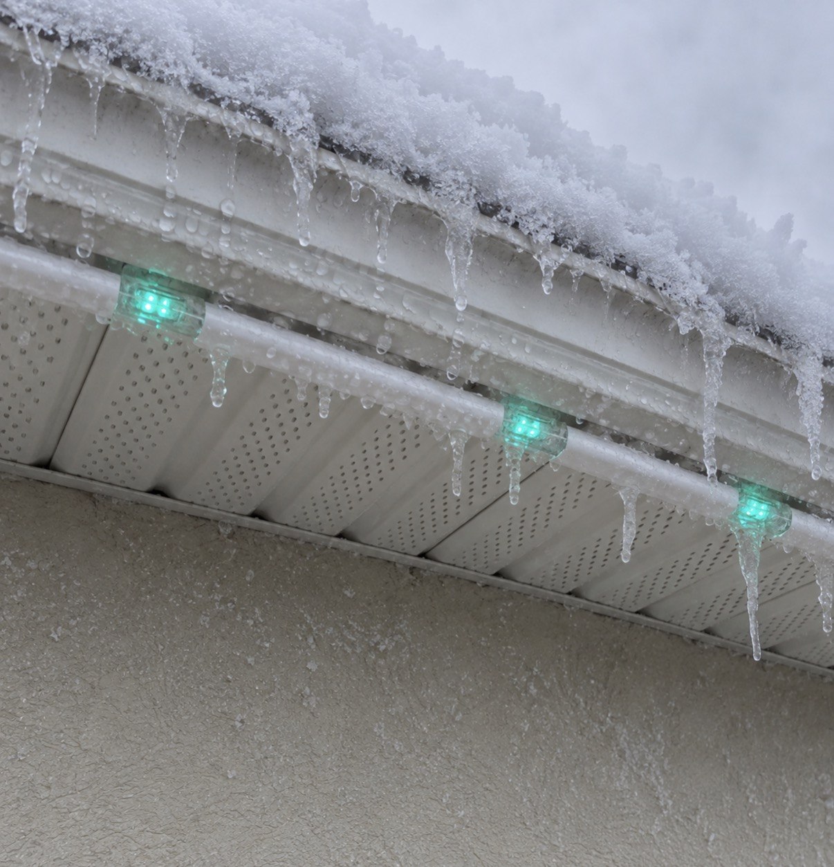 Wise permanent-lighting track fitted beneath a snow- and ice-covered Ottawa soffit